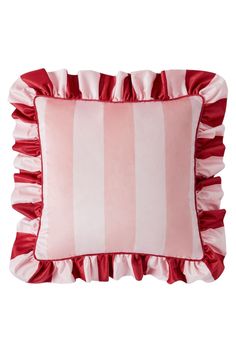 a red and white striped pillow with ruffles on the bottom, in front of a