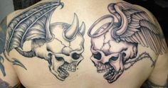 two skulls with horns and wings on the back of a man's shoulder tattoo