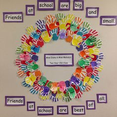 a bulletin board with handprints on it and words around the circle that spell out