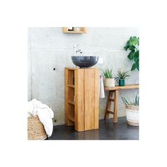 a bathroom with a sink, mirror and wooden cabinet next to a potted plant