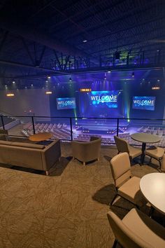 an empty church with chairs and tables on the stage for people to sit in it