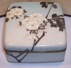 a blue and white box with flowers on it