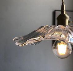 a light that is hanging from the ceiling with a lamp on it's side