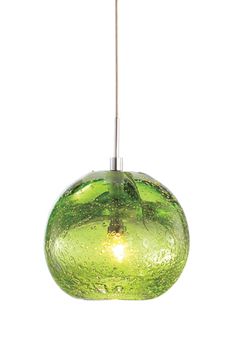 a green glass light hanging from a ceiling