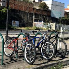 three bikes are parked next to each other on the street