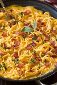 a skillet filled with pasta and bacon