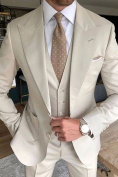 a man in a white suit and tie