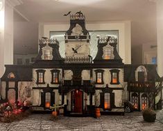 a black and white house with pumpkins on the ground