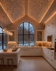 a kitchen filled with lots of counter top space under a ceiling covered in stars and lights