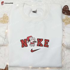 The Nike x Snoopy Christmas Santa Claus Embroidered Sweatshirt is the perfect festive attire. It features a charming Santa Claus embroidery, adding a touch of holiday cheer. Made with soft and comfortable fabric, it provides warmth and coziness during the winter season. This limited edition collaboration between Nike and Snoopy allows you to express your love for both brands. Stand out from the crowd and spread joy with this unique and stylish sweatshirt. Get ready to celebrate the holidays in s Candy Cane Nike Sweatshirt, Nike Embroidered Sweatshirt, Nightmare Before Christmas Hoodie, Disney Characters Christmas, Candy Cane Gifts, Santa Sweatshirt, Snoopy Christmas, Family Christmas Gifts, Shirt Embroidery