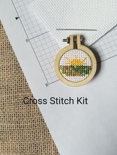 the cross stitch kit is laying on top of a piece of paper