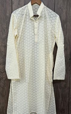 Men's cotton cream kurta with all over embroidery and sequins highlights. SIzes mentioned are actual kurta chest measurements. Off White Cotton Kurta With Printed Motifs, Festive Cream Kurta With Printed Motifs, White Traditional Wear With Printed Motifs For Summer, Summer White Traditional Wear With Printed Motifs, White Summer Traditional Wear With Printed Motifs, Spring Cream Chikankari Traditional Wear, Cream Long Sleeve Kurta With Printed Motifs, Beige Cotton Kurta With Printed Motifs, Cream Cotton Straight Kurta