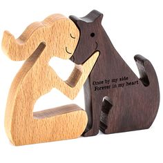 two wooden figurines sitting next to each other on a white background with the words, once by my side forever in my heart