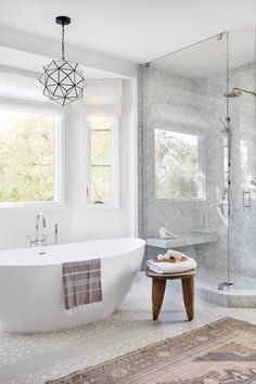 a white bath tub sitting next to a window