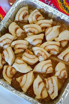 a pan filled with sliced bananas sitting on top of a table next to a bag of chips