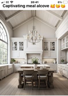 an image of a kitchen setting with white cabinets and wood flooring in the middle