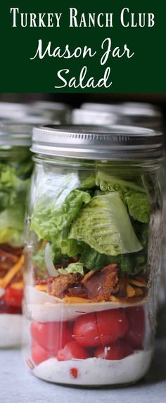 two mason jar salads with lettuce and tomatoes