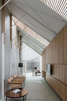 the inside of a large building with wooden walls and flooring on either side of it