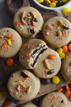 some cookies with candy on top of them next to a bowl of corn kernels