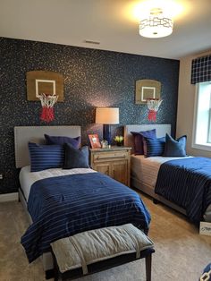 a bedroom with two beds and basketball hoop on the wall