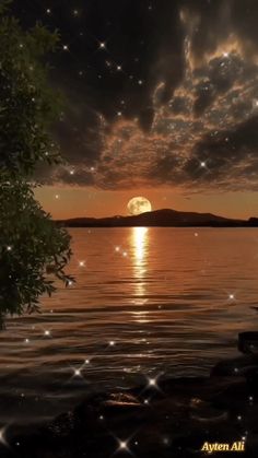 the sun is setting over water with stars in the sky