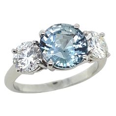 three stone ring with blue and white topaz