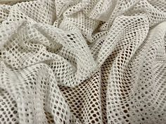 a close up view of a white knitted material