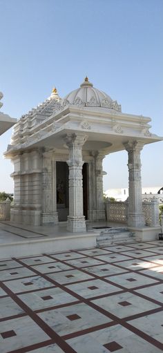 an ornate white building with pillars and arches