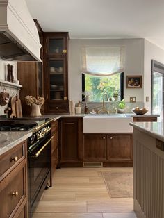 an image of a kitchen setting with wood cabinets and marble counter tops on the left side