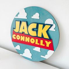 a wooden sign that says jack and the beans on it's side, with clouds in the background