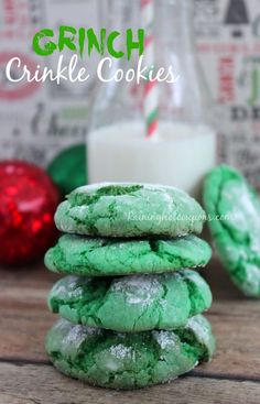 green crinkle cookies stacked on top of each other next to a glass of milk