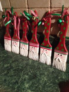 four red and green christmas decorations sitting on top of a counter next to a brick wall