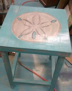 a blue table with a flower painted on it