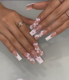 Flower Long Nails, Pink And White Bling Nails, Lavender Butterfly Quinceanera Nails, White And Purple Nails, Lavender Butterfly Nails Quince, Quince Nails Purple Butterfly, Pink Flower Quince Nails, Long Acrylic Nails 3d Flower Pink, Nail Ideas