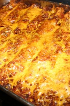 a cheesy casserole in a pan on top of the stove ready to be eaten