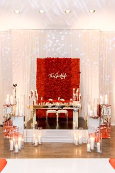 a red and white wedding setup with candles