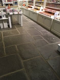 a store filled with lots of different types of items on the floor and shelves in front of them