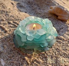 a candle that is sitting in the sand