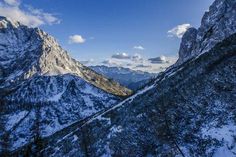 the mountains are covered in snow under a blue sky