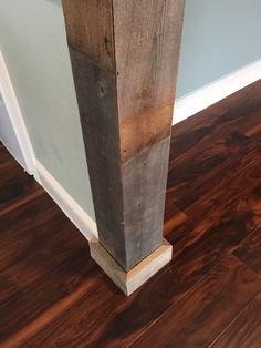 a wooden column in the corner of a room