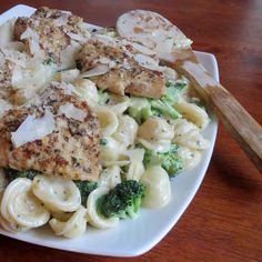 pasta with chicken and broccoli on a white plate