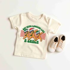 "Toddlers will look adorable in this \"OUT HERE LOOKING LIKE A SNACK CHRISTMAS\" SANTA youth short sleeve tee. This lightweight side-seamed shirt maximizes comfort all day long.  Gingerbread Out Here Looking Like A Snack Toddler Baby TShirt, Cute Santa Claus Shirt, Retro Christmas T-Shirt, Funny Santa Tee, Holiday Sweater, Santa Gift, Santa Funny tshirt, Cute Santa shirt, Retro Santa Shirt, Christmas Sweatshirt, Christmas Santa Shirts, Cute Retro Gingerbread Santa Shirt, Classic Christmas Shirt, Snack Christmas, Gingerbread Santa, Gingerbread Shirt, Looking Like A Snack, Santa Graphic, Santa Tee, Christmas Pullover, Santa Sweatshirt, Retro Santa