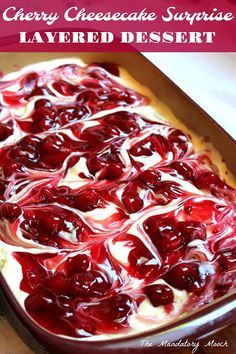 cherry cheesecake surprise layered dessert in a baking dish with cherries on top and the words cherry cheesecake surprise layered dessert below