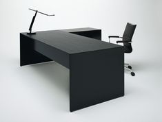 an office desk with a chair next to it