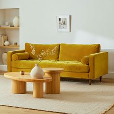 a living room with yellow furniture and white walls