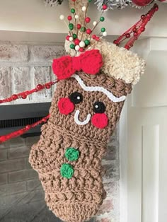 a crocheted stocking hanging from a fireplace mantel decorated with christmas decorations