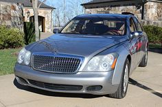 a silver car parked in front of a house