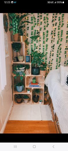 a bed room with a neatly made bed and lots of plants