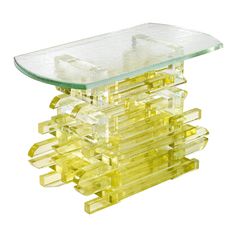 a glass table with yellow plastic pieces stacked on top of each other and one piece missing