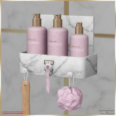 three pink soaps are hanging on a marble shelf with hooks and hairbrushes